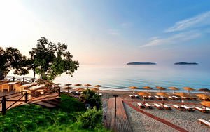 Vasilias beach in Skiathos, bathed in hues of blue, pink, and orange